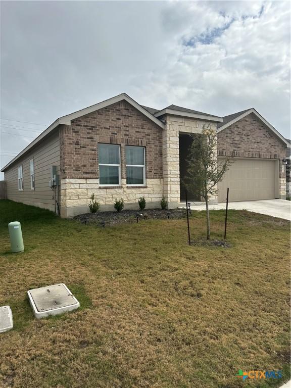 view of front of property with a garage and a front yard