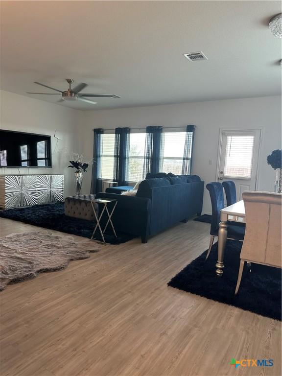 living room featuring hardwood / wood-style flooring and ceiling fan