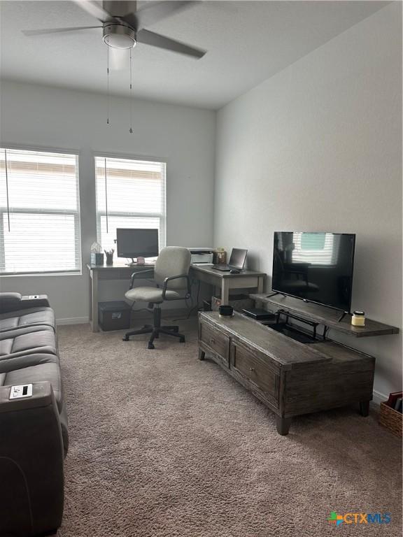 carpeted office with ceiling fan