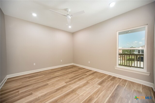 empty room featuring light wood-type flooring and ceiling fan