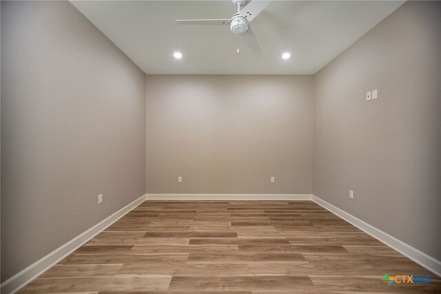 spare room featuring ceiling fan and light hardwood / wood-style flooring