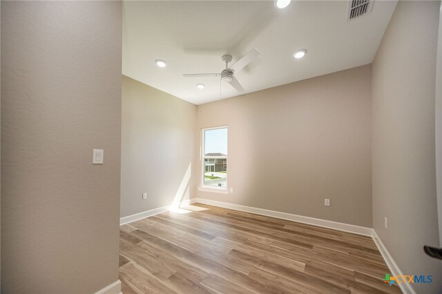 unfurnished room featuring ceiling fan and light hardwood / wood-style flooring