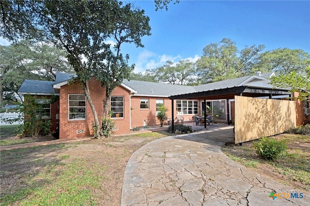 929 E Cedar St, Seguin, TX 78155 - view of front of home featuring brick siding, a patio, and a carport