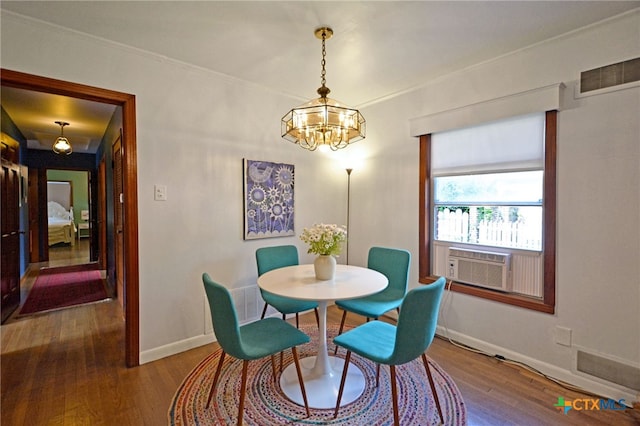 929 E Cedar St, Seguin, TX 78155 - dining room featuring wood finished floors, a chandelier, cooling unit, and ornamental molding