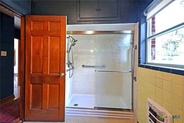 929 E Cedar St, Seguin, TX 78155 - bathroom featuring a shower stall and radiator heating unit