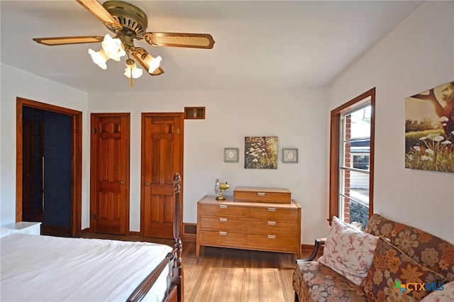 929 E Cedar St, Seguin, TX 78155 - bedroom with wood finished floors, a ceiling fan, and two closets
