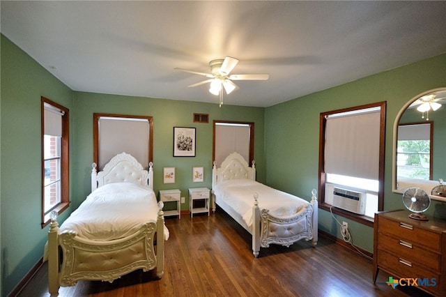 929 E Cedar St, Seguin, TX 78155 - bedroom featuring cooling unit, dark wood-style floors, and ceiling fan
