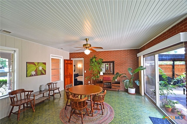 929 E Cedar St, Seguin, TX 78155 - dining area with tile patterned floors, brick wall, a ceiling fan, and wood ceiling