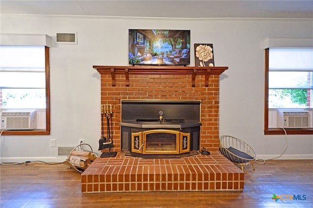 929 E Cedar St, Seguin, TX 78155 - detailed view of cooling unit, a brick fireplace, wood finished floors, and ornamental molding