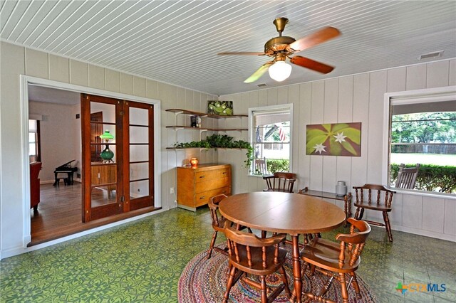 929 E Cedar St, Seguin, TX 78155 - dining area featuring french doors, tile patterned floors, wooden ceiling, a ceiling fan, and wood walls