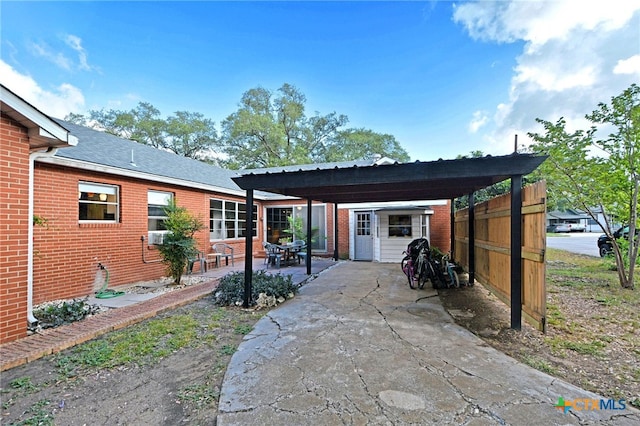 929 E Cedar St, Seguin, TX 78155 - view of patio featuring concrete driveway and a carport