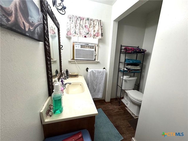 308 Avenue E Ave E, Victoria, TX 77901 - bathroom with cooling unit, vanity, and wood finished floors
