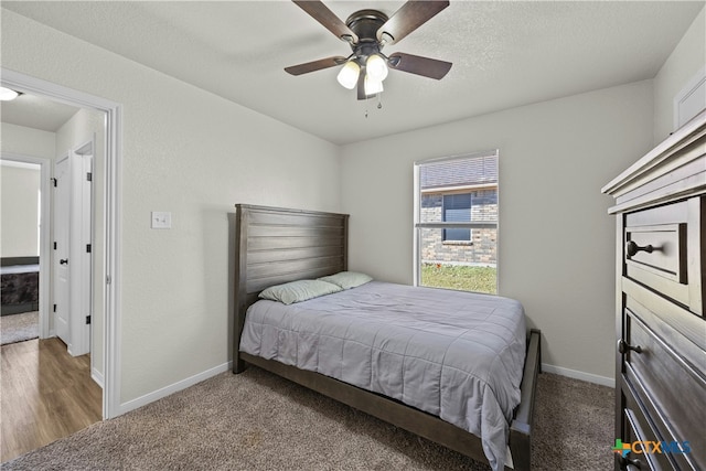 bedroom with dark colored carpet and ceiling fan