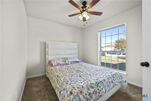 bedroom featuring dark colored carpet and ceiling fan