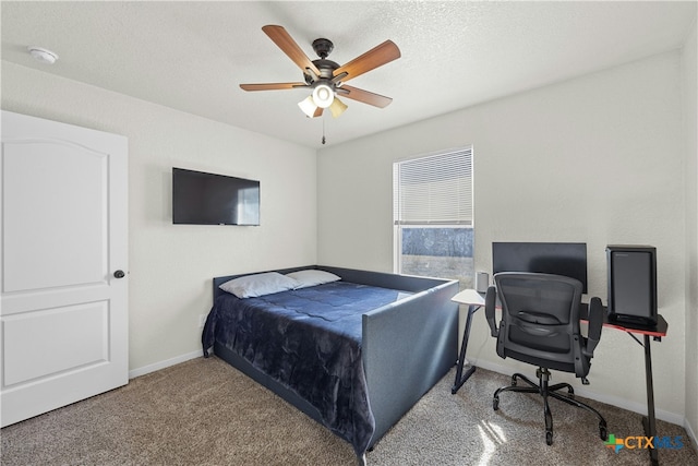 carpeted bedroom featuring a textured ceiling and ceiling fan