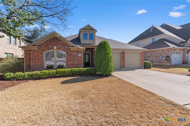 view of front of property featuring a garage, brick siding, roof with shingles, and driveway