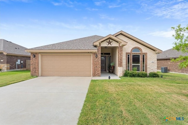 4004 Brookside Dr, Killeen, TX 76542 - view of front facade with brick siding, a garage, driveway, and a front lawn