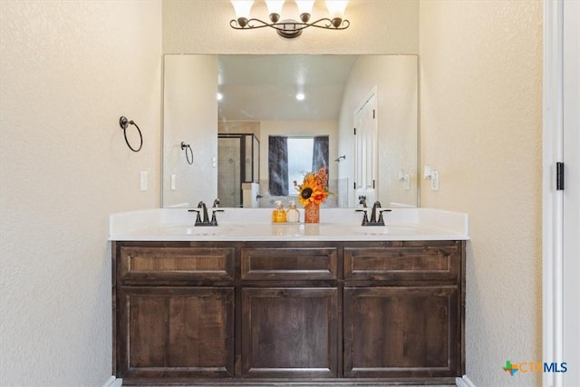 4004 Brookside Dr, Killeen, TX 76542 - full bathroom featuring double vanity, a textured wall, and a shower stall