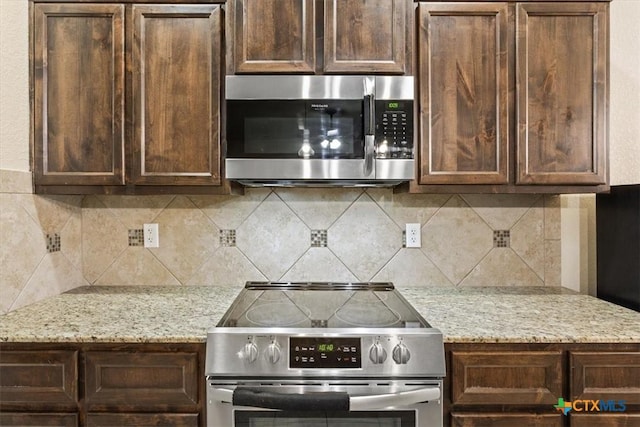 4004 Brookside Dr, Killeen, TX 76542 - kitchen featuring stainless steel appliances, dark brown cabinets, and decorative backsplash