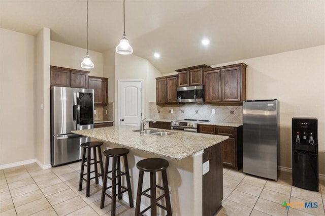 4004 Brookside Dr, Killeen, TX 76542 - kitchen featuring stainless steel appliances, light tile patterned floors, tasteful backsplash, dark brown cabinetry, and light stone counters