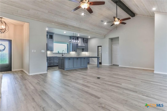 916 Stone Rd, Temple, TX 76501 - kitchen featuring a sink, a wealth of natural light, vaulted ceiling with beams, and wall chimney exhaust hood