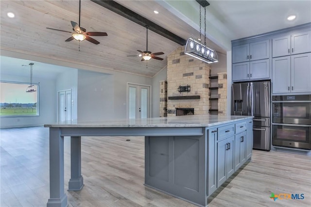 916 Stone Rd, Temple, TX 76501 - kitchen with stainless steel refrigerator with ice dispenser, double oven, a ceiling fan, open floor plan, and a kitchen island
