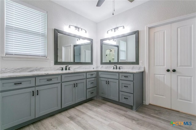 916 Stone Rd, Temple, TX 76501 - bathroom featuring a ceiling fan, wood finished floors, and double vanity