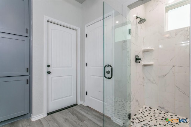 916 Stone Rd, Temple, TX 76501 - full bathroom featuring a marble finish shower and wood finished floors