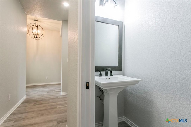 916 Stone Rd, Temple, TX 76501 - bathroom featuring wood finished floors, baseboards, and a textured wall