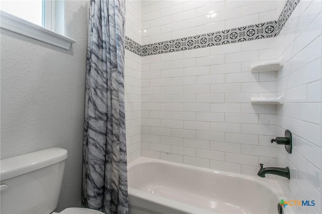 916 Stone Rd, Temple, TX 76501 - bathroom with toilet, a textured wall, and shower / bath combination with curtain