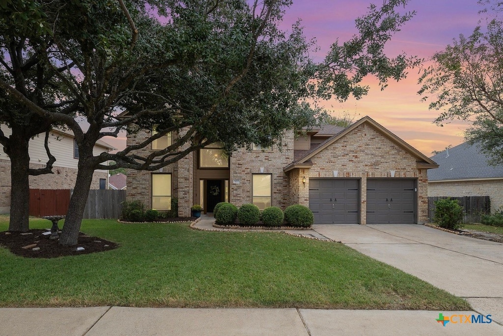 view of front facade with a lawn and a garage