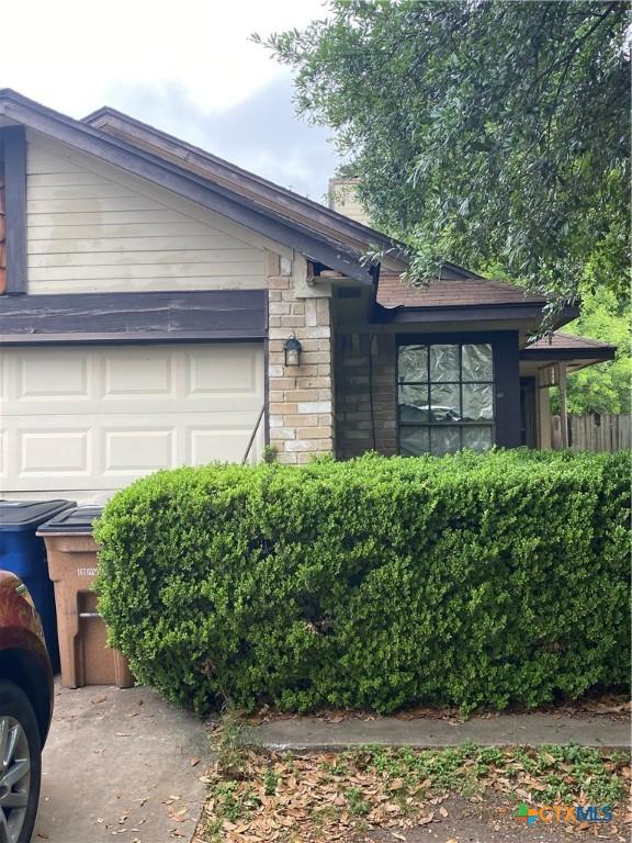1318 Deupree Dr, Austin, TX 78753 - ranch-style home with a garage and stone siding