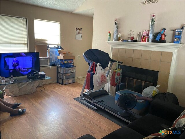 1318 Deupree Dr, Austin, TX 78753 - exercise area featuring a fireplace and wood finished floors