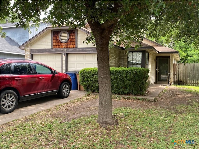 1318 Deupree Dr, Austin, TX 78753 - view of front of home with a garage, fence, and concrete driveway