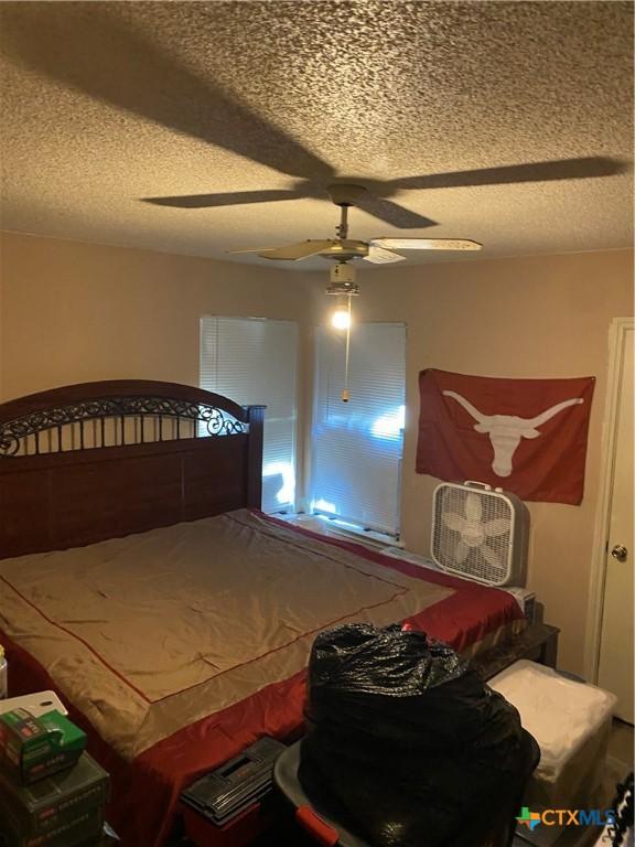1318 Deupree Dr, Austin, TX 78753 - bedroom with a textured ceiling and a ceiling fan