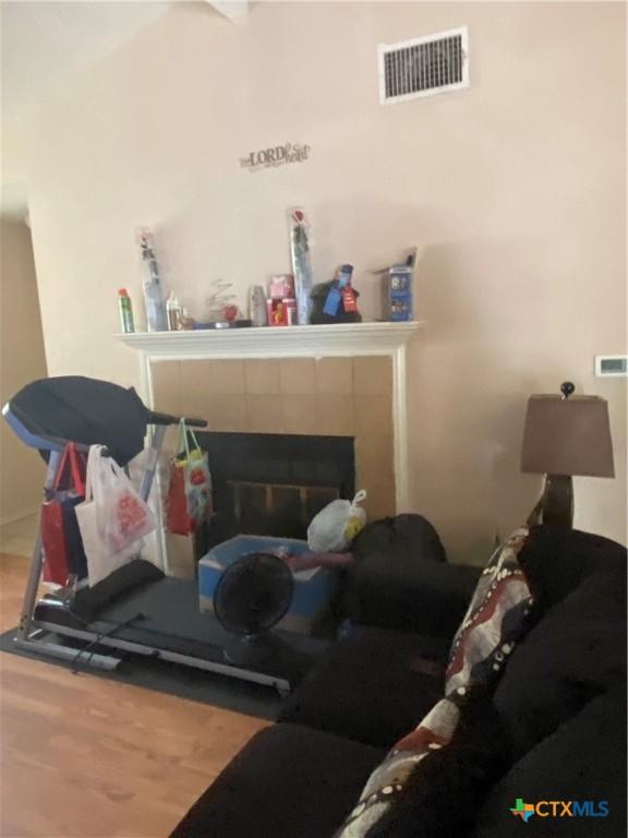 1318 Deupree Dr, Austin, TX 78753 - living area with wood finished floors and a fireplace