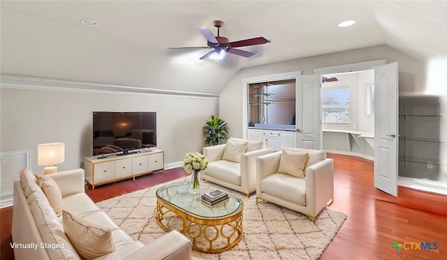 living room featuring vaulted ceiling, ceiling fan, and hardwood / wood-style flooring