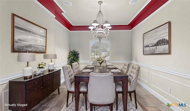 dining area featuring ornamental molding and a notable chandelier