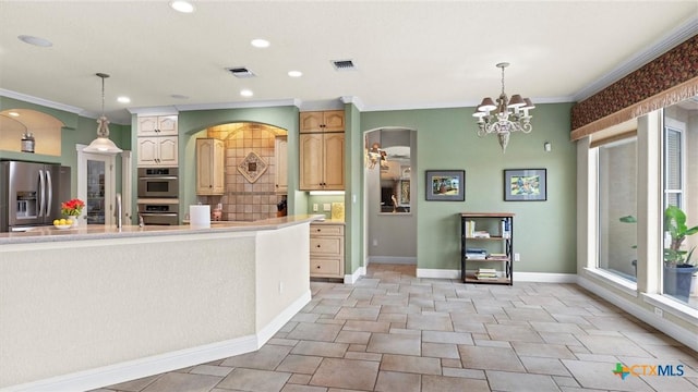 kitchen featuring decorative light fixtures, stainless steel appliances, a notable chandelier, and a healthy amount of sunlight