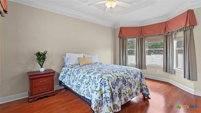 bedroom with ceiling fan, wood-type flooring, and ornamental molding