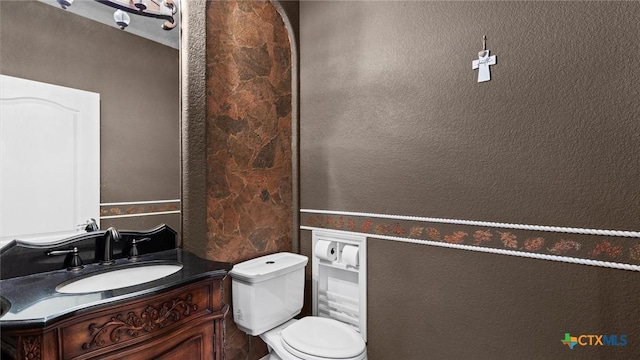 bathroom featuring toilet and vanity