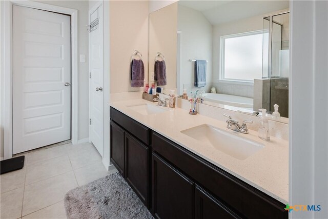 228 Sage Meadows Dr, San Marcos, TX 78666 - full bathroom featuring tile patterned floors, a garden tub, double vanity, and a stall shower