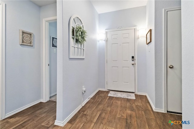 entrance foyer featuring baseboards and wood finished floors