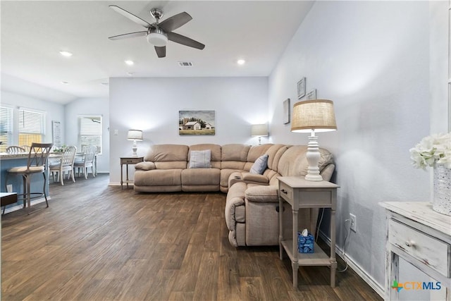 living area featuring visible vents, recessed lighting, baseboards, dark wood-style flooring, and vaulted ceiling