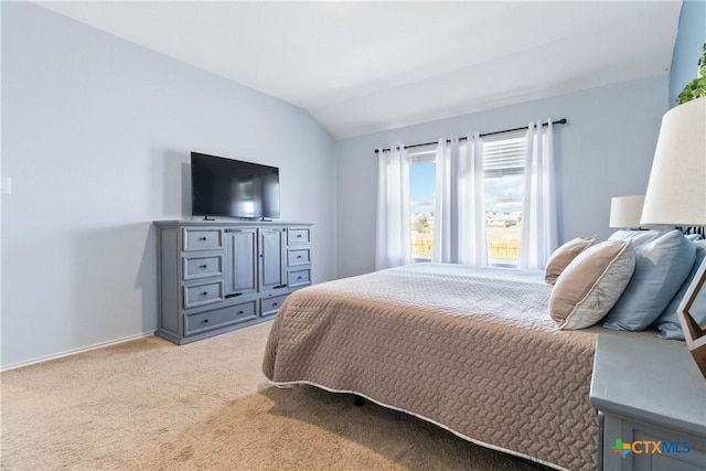 bedroom with light carpet, baseboards, and vaulted ceiling