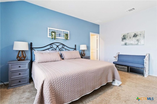 carpeted bedroom with baseboards and visible vents