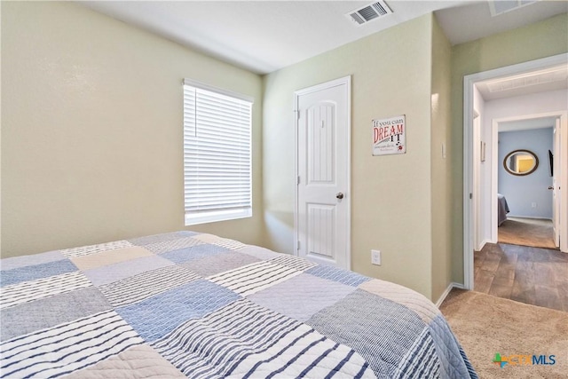 bedroom featuring carpet, visible vents, and baseboards