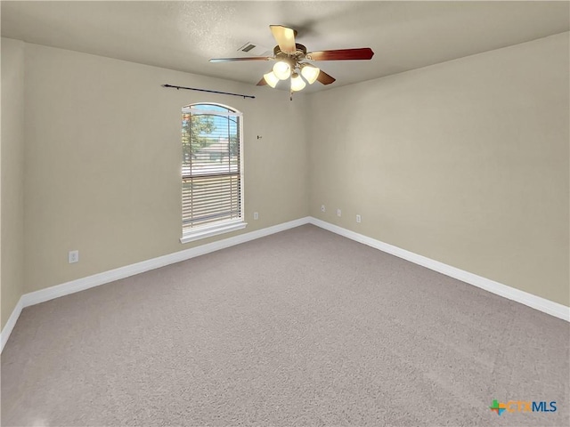 spare room featuring carpet flooring and ceiling fan