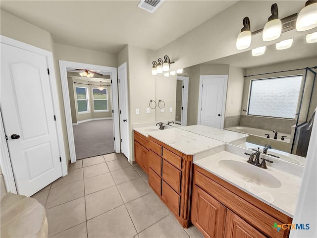 bathroom featuring tile patterned flooring, vanity, a wealth of natural light, and ceiling fan