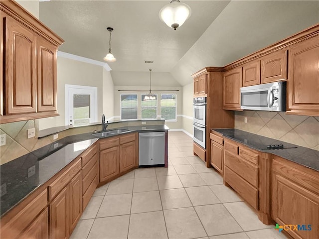 kitchen featuring backsplash, pendant lighting, stainless steel appliances, and lofted ceiling